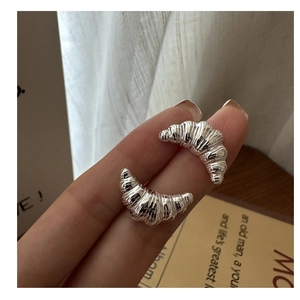 Close-up of S925 sterling silver croissant hoop earrings with elegant pleated texture