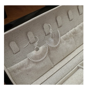 Detailed macro shot of S925 sterling silver fan-shaped earrings with hollow linear design