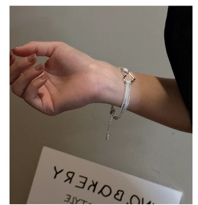 Detailed close-up of S925 sterling silver double-strand heart bracelet on a wrist