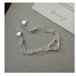 Detail shot of S925 sterling silver multi-strand chain bracelet with heart charms