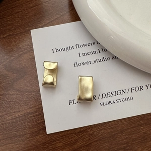 925 Sterling Silver matte gold textured clip earrings on a minimalist card
