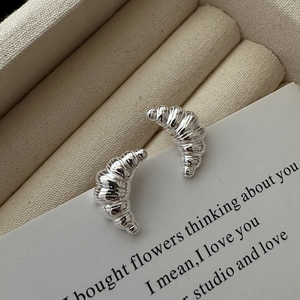 Minimalist S925 sterling silver croissant stud earrings with elegant metallic texture