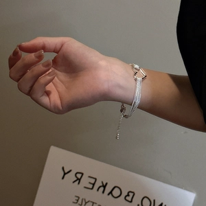 S925 sterling silver multi-chain heart bracelet worn on wrist with adjustable extension