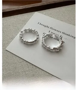 Detail of S925 sterling silver rings with irregular folded texture and open design