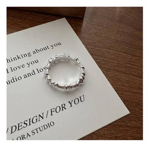 Detailed view of S925 sterling silver ring with twisted pleated texture and open design