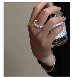 Close-up of S925 sterling silver stacked ring with unique pleated spiral texture