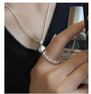 Detail of S925 sterling silver ring with crinkle texture and matching ball pendant necklace