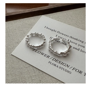Detail of two S925 sterling silver open rings featuring irregular wrinkled textures
