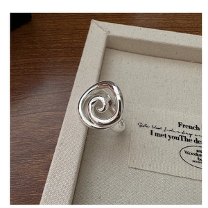 Macro shot of minimalist spiral S925 sterling silver ring showing the inner hallmarking