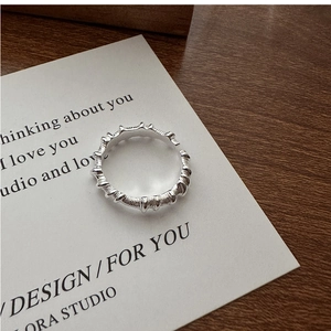 Detail of S925 sterling silver ring with irregular wrinkled texture and open band design