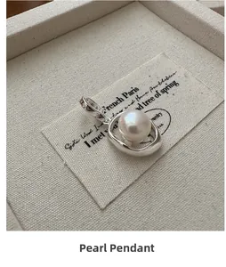 Macro shot of S925 silver organic ring pendant featuring a large white round pearl