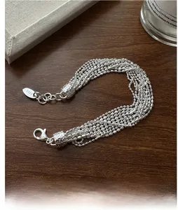 Detailed close-up of S925 sterling silver multi-layer beaded bracelet with hallmark tag