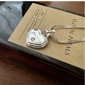 Gros plan du pendentif cœur en argent S925 avec gravure Beckoning et oxyde de zirconium