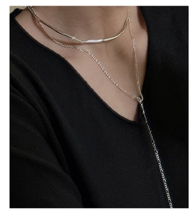 Detail of layered S925 sterling silver liquid-style choker with irregular wave texture