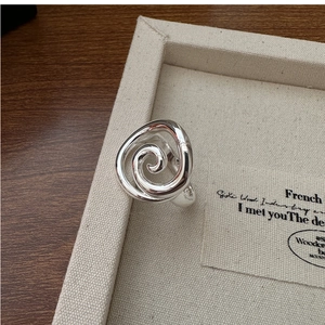 Detailed macro view of S925 sterling silver minimalist spiral ring showing the hallmark