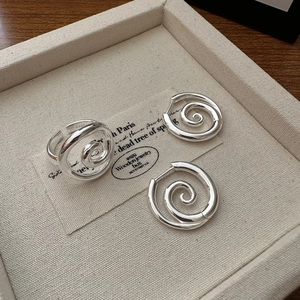 Minimalist S925 sterling silver spiral jewelry set with ring and earrings on linen tray