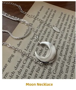 Detail of S925 sterling silver double-layer necklace with a polished crescent moon pendant