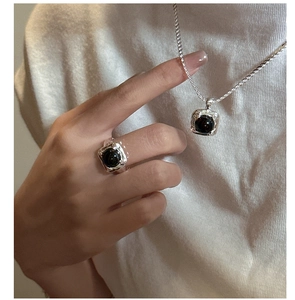 Detail shot of a black agate necklace and ring set with square hammered silver texture