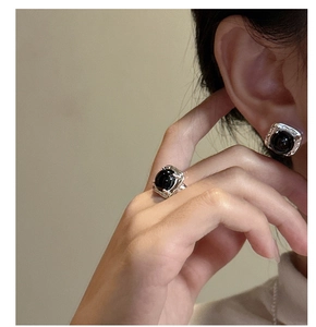 Detail of retro S925 silver ring and earrings set with round black onyx stones