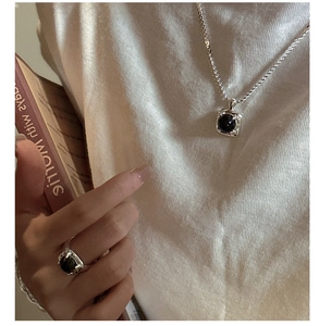 Detailed view of S925 silver necklace and ring set with minimalist black onyx stones