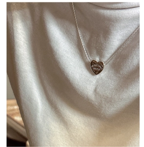 Close-up of S925 sterling silver heart necklace with Expectation Future engraving