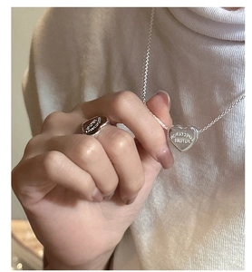 Close-up of S925 silver heart necklace and ring set with expectation engraving