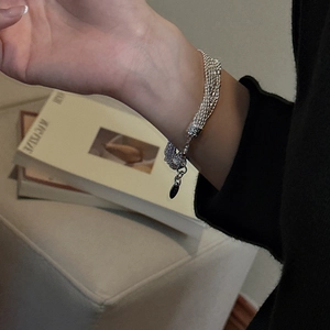 S925 sterling silver multi-strand woven bracelet with a polished metal disc tag
