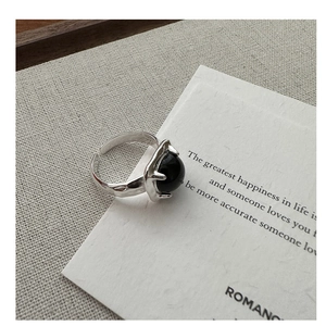 Macro detail of S925 silver adjustable ring with black agate and hammered texture