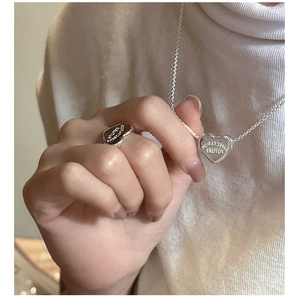 Detail of S925 silver heart necklace and ring engraved with Expectation Future text