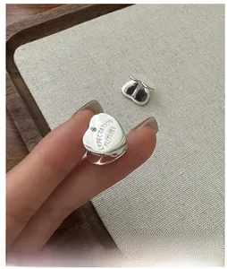 Macro shot of S925 sterling silver heart hoop earrings with expectation future engraving