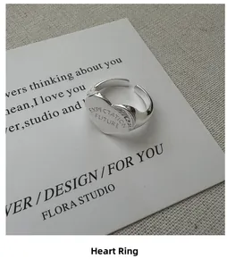 Close-up of heart-shaped S925 silver ring engraved with Expectation Future text