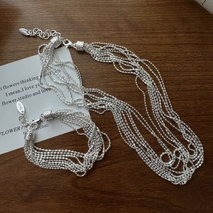 S925 sterling silver multi-strand bead necklace and bracelet set on wooden desk