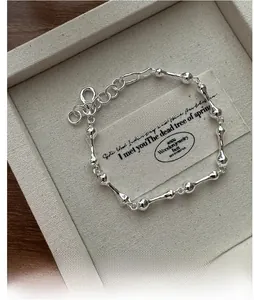 Detailed view of S925 sterling silver bone link bracelet in a minimalist jewelry box