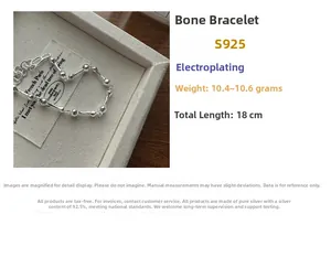 Detail view of S925 sterling silver bone-shaped link bracelet with sizing specifications