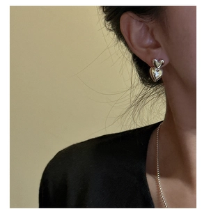 Detail of S925 sterling silver double heart earrings shown on a model for daily wear