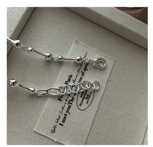 Close-up of S925 sterling silver chain bracelet with unique knot and bead links