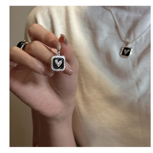 Detail of S925 silver heart necklace and ring set with black enamel and zircons
