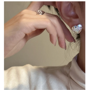 Detail of polished S925 sterling silver heart earrings and ring with custom engraving