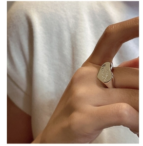 Close-up of S925 sterling silver heart signet ring with Expectation engraving