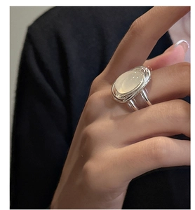 Close-up of S925 silver ring featuring an oval translucent agate stone in a layered band