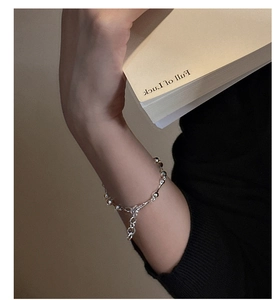 Detail of S925 sterling silver beaded bracelet with lobster clasp on model wrist