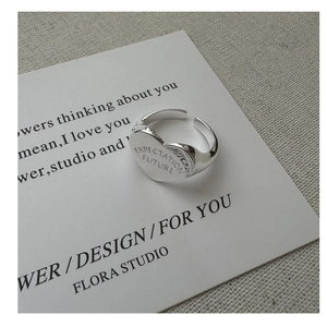 Macro detail of S925 sterling silver heart ring with Expectation and Future engraving