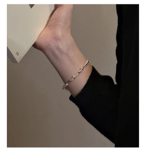 Close-up of minimalist S925 sterling silver beaded bracelet worn for a stylish look