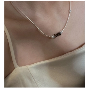 Detailed shot of S925 sterling silver tube chain necklace with brown gemstone accents