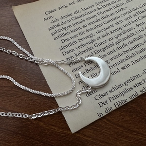 S925 sterling silver double-layer moon necklace on vintage paper background