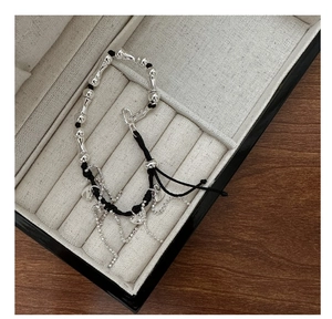 Detailed shot of S925 silver heart tassel bracelet with bamboo beads on jewelry box
