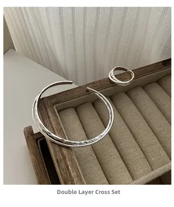 Close-up of S925 sterling silver double-layer cross bangle and ring with ripple texture