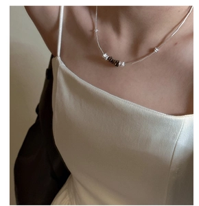 Close-up of S925 sterling silver necklace with crushed stones on a model's collarbone