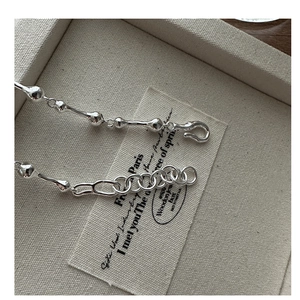 Detailed macro view of S925 sterling silver bone-shaped chain with adjustable extender