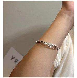 Detail of S925 sterling silver open bracelet with irregular hammered texture on wrist